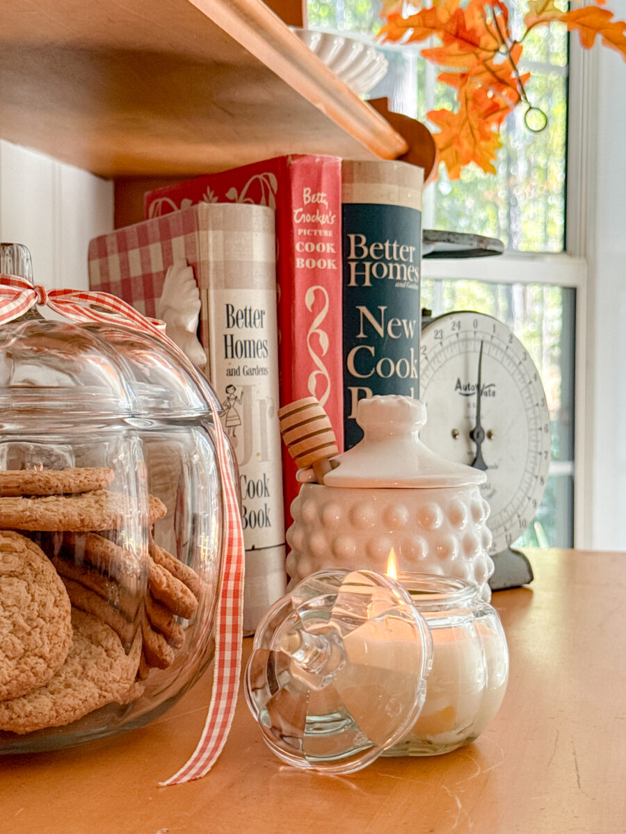 DIY Beeswax candle in pumpkin jar, glass pumpkin cookie jar with ribbon and white milk glass honey pot.