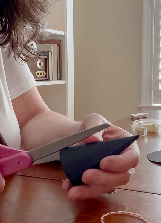 Cutting slits to make a tiny paper witch hat