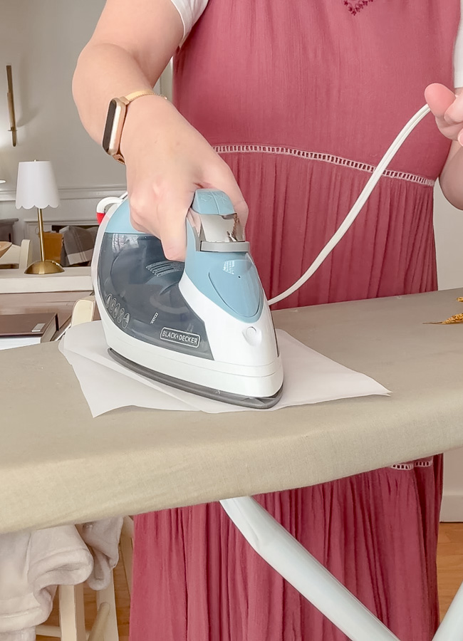 Ironing parchment paper that has a leaf inside.