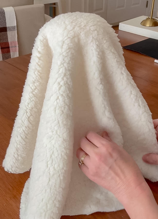 Draping sherpa fabric over body to make ghost