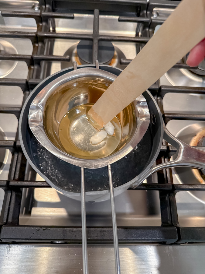 Melting beeswax in double boiler for DIY candle wicks