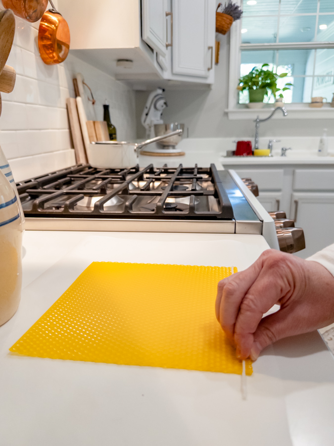 Rolling beeswax sheet over a wick