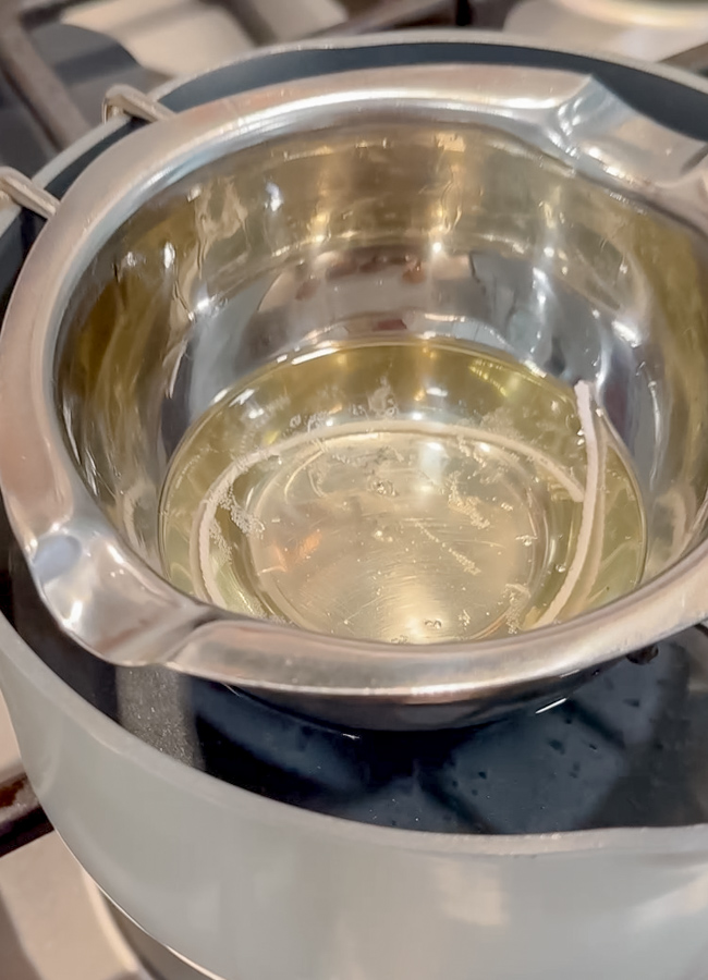 How to make a beeswax candle wick by submerging it in hot liquid beeswax