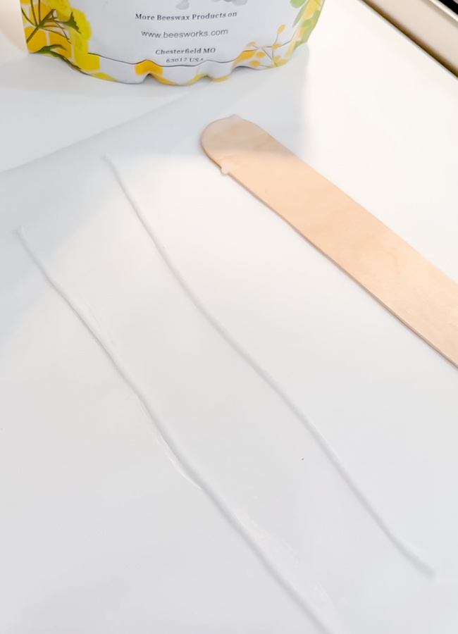 Homemade candle wicks on parchment paper