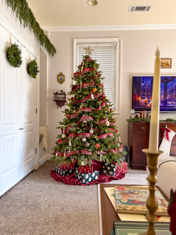 Living room with Ralph Lauren style Christmas tree.  Green tree with vintage ornaments, plaid ribbon and burgundy velvet skirt