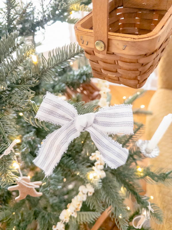 Fabric torn ribbon in blue and white ticking fabric bows on a Christmas tree