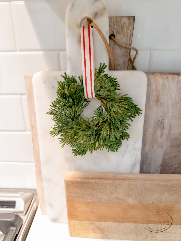 Old cutting boards with mini wreath.
