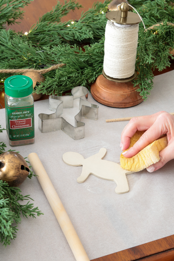 Smooth the clay with a damp sponge to make a gingerbread ornament
