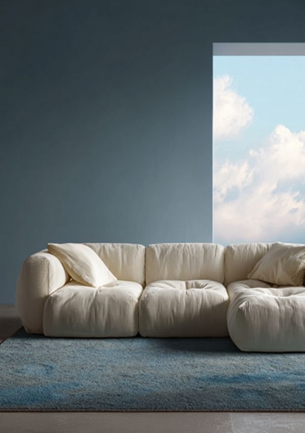 Pantone paint color of the year cloud dancer on a sofa