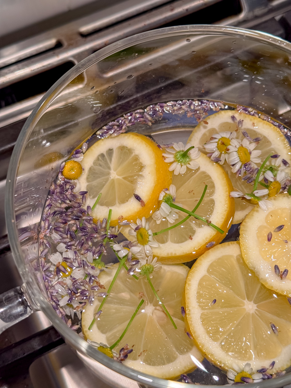 Spring simmer pot recipe - lemon, lavender, chamomile and rosemary in a clear glass pot.