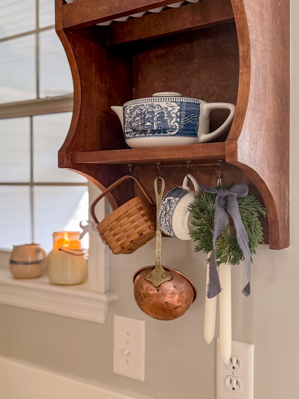 Winter kitchen decor leaving the Christmas mini wreath on the wall hutch.