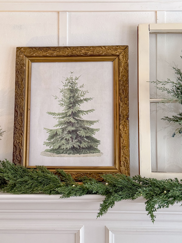 Non Christmas Winter Decor of cedar garland and fir tree printable art in an old vintage frame.