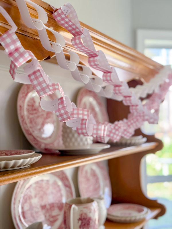 Heart paper chains draped across an old vintage hutch