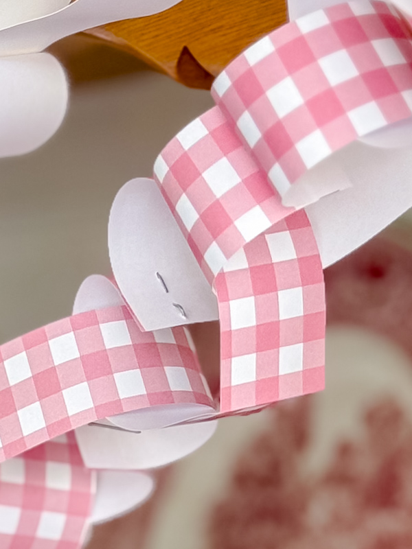 Close up of paper heart chain staples