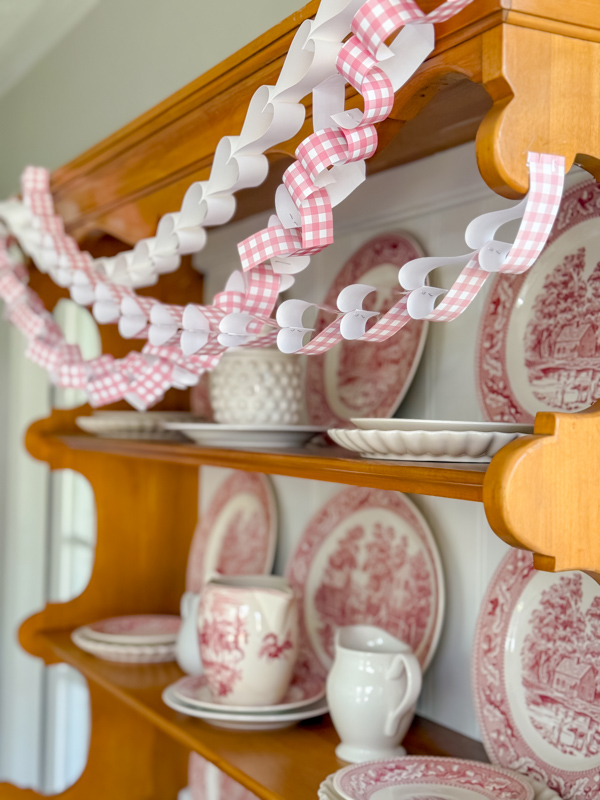 Vintage hutch decorated for Valentine's day with heart paper chains