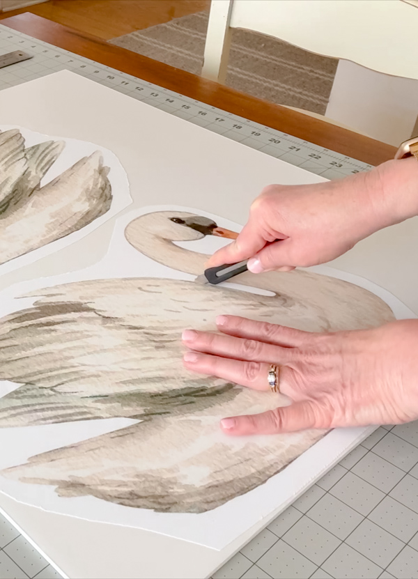 Cut along the edge of your swan with an xacto knife. Pull away pieces as you go.