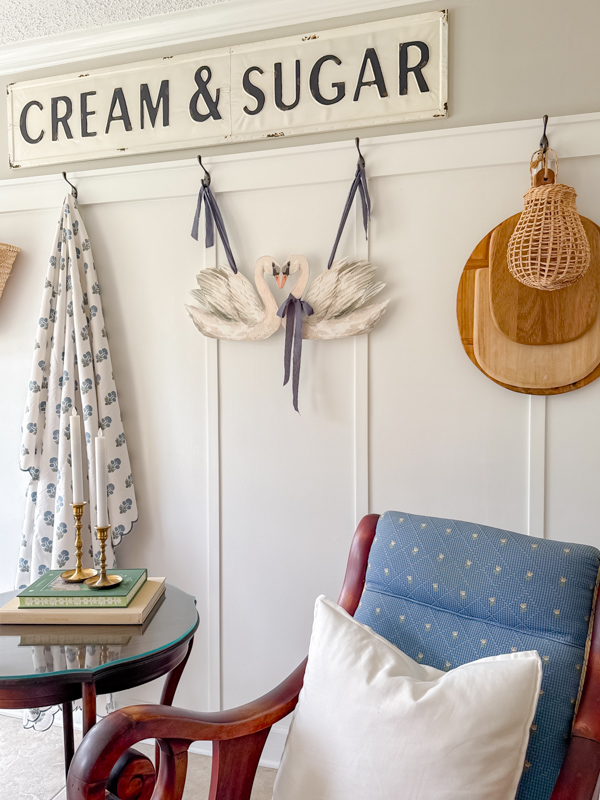 Wall decor for spring with watercolor swans in love diy, wood cutting boards and block print throw.