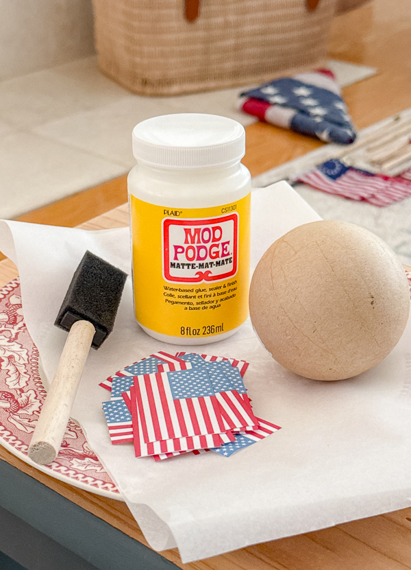 Supplies to make DIY American flag decoupage balls.