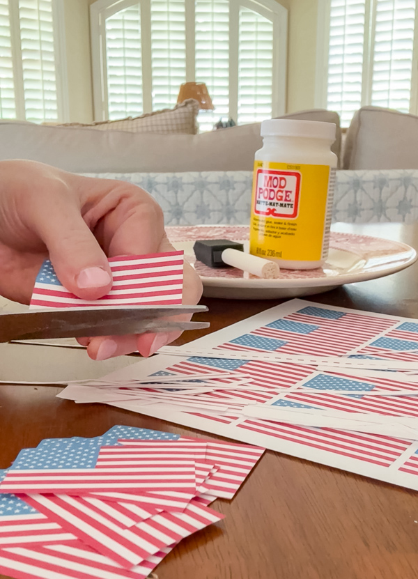 Cutting mini paper flags to make orbs for a dough bowl