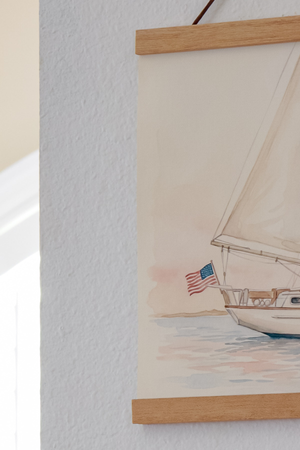 Close up of printable art on printer canvas paper of a sailboat with an american flag flying off the back of the boat