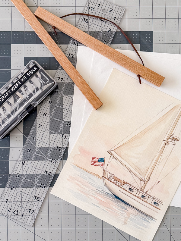 Supplies needed to print on canvas paper at home including inkjet canvas paper, cutting mat, X-ACTO knife, magnetic frame, and a finished canvas art print