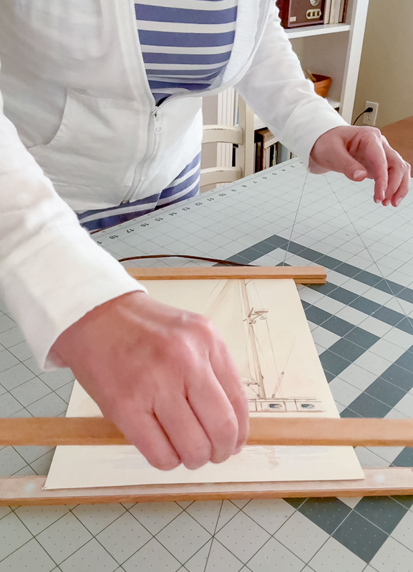 Framing a sailboat canvas print using a magnetic wood frame that attaches to the top and bottom of the printed canvas art