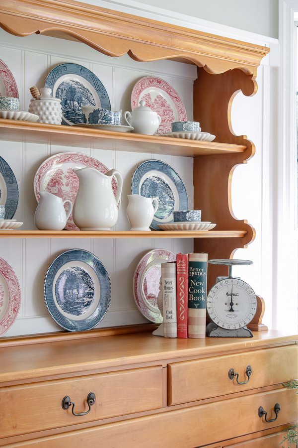 Vintage pine hutch styled with red and blue transferware plates and white ironstone pitchers for year-round Americana home decor
