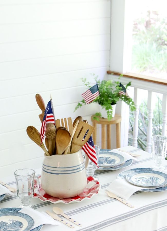 Patriotic table setting on a back porch with a vintage pitcher and Betsy Ross flag