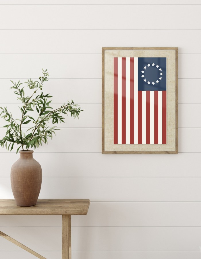 Printable Betsy Ross vintage flag hanging on a wall in a frame with a linen background.