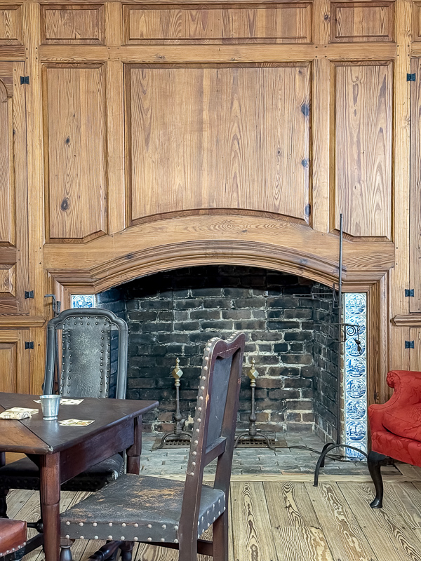 Raised panel fireplace design around the fireplace box found at George Washingtons birthplace. Note the delft tiles on the sides of the fireplace. This is a fantastic idea for a newer home to make it look old.