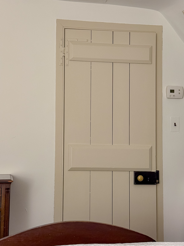 Handmade door at Williamburg with wood vertical beams and three cross beams.