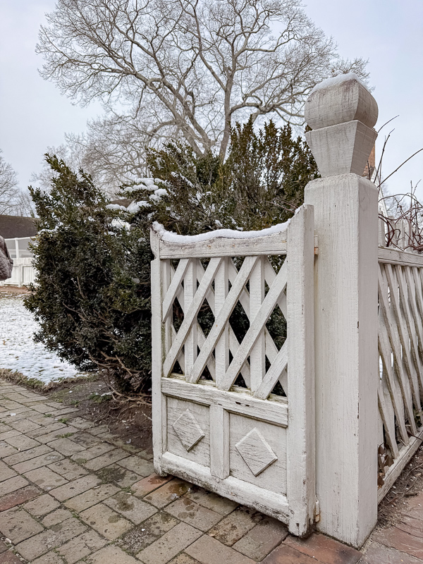 Garden gate design with large post and lattice design on top and panel diamond design on bottom.