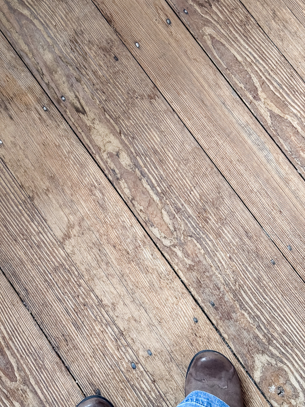 Wood floors layed with old nails in different size widths and unfinished.