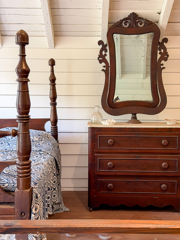 Add old furniture to your newer home to build warmth and character. This ornate chest with mirror and four poster bed is a great idea found at Belleview plantation.