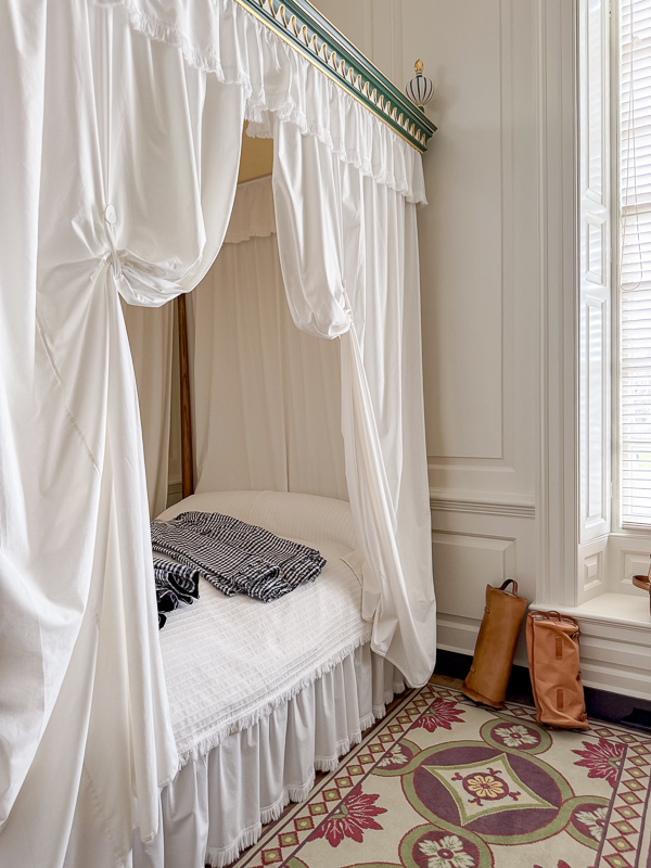 Simple white ruffled canopy bed at Colonial Williamsburg