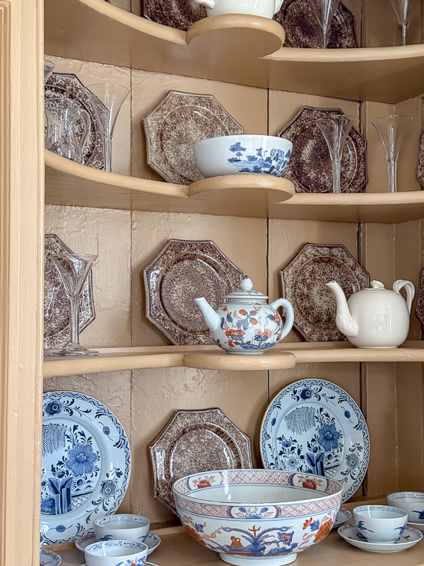Built-in pantry shelving styled with ironstone and blue and white china