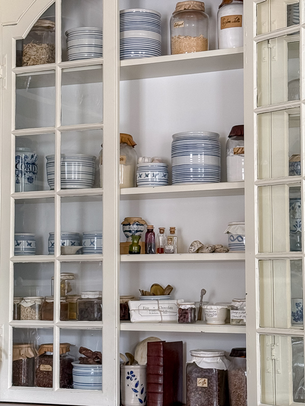 Apothecary cabinet styled with blue and white pottery