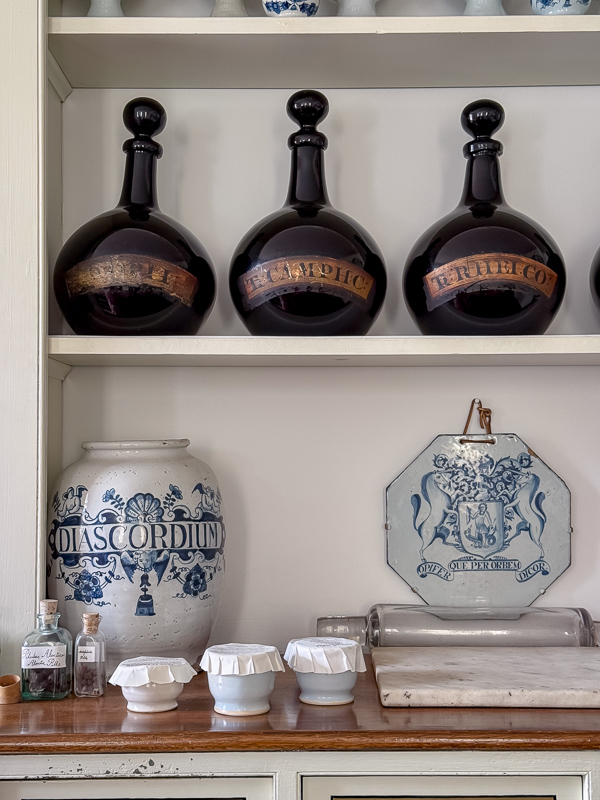 Built-in pantry shelving styled with ironstone and blue and white china