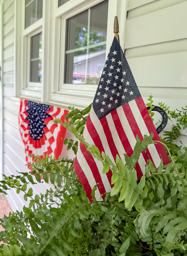 Stick flags in ferns and red, white and blue swags.