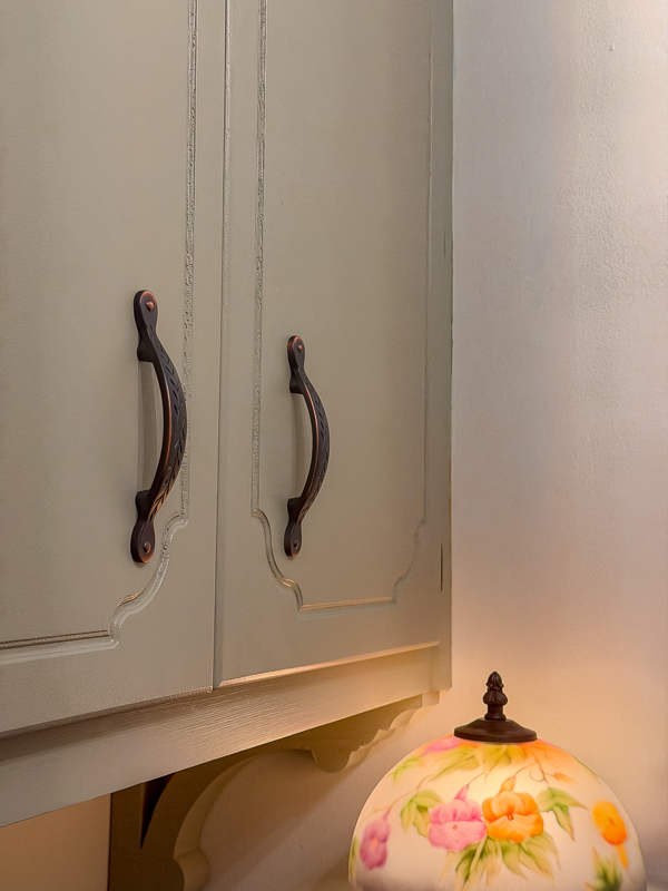 Bronze ivy pulls from Lowes on a green cabinet