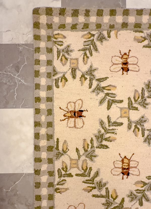 Wool hook rug with bees and ivy.
