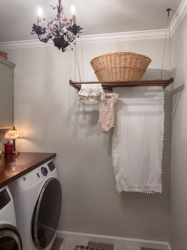 Shiela Made with vintage basket on it and baby clothes hanging on it.