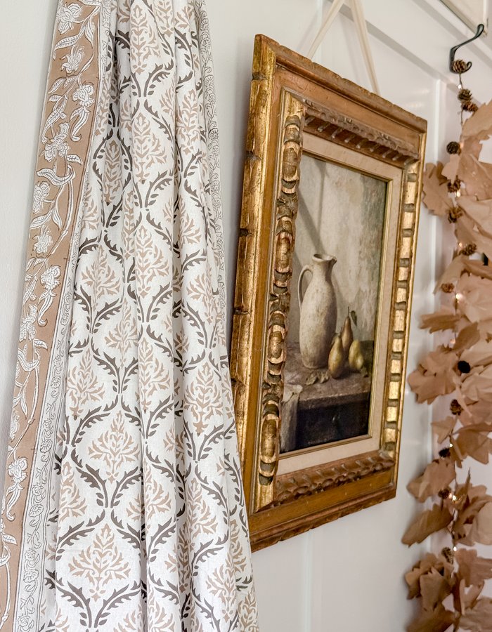 Angled view of the gilt art print showing the ironstone pitcher and pears against the distressed painted background