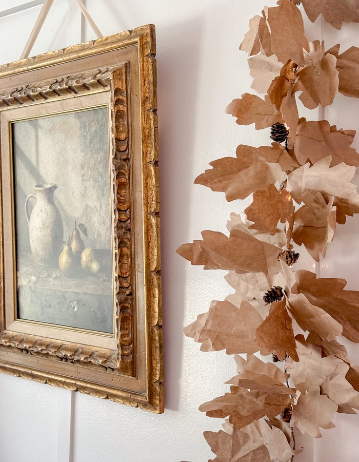 The gilt art print paired with the handmade paper leaf garland from Amazon brown packing paper and fairy lights