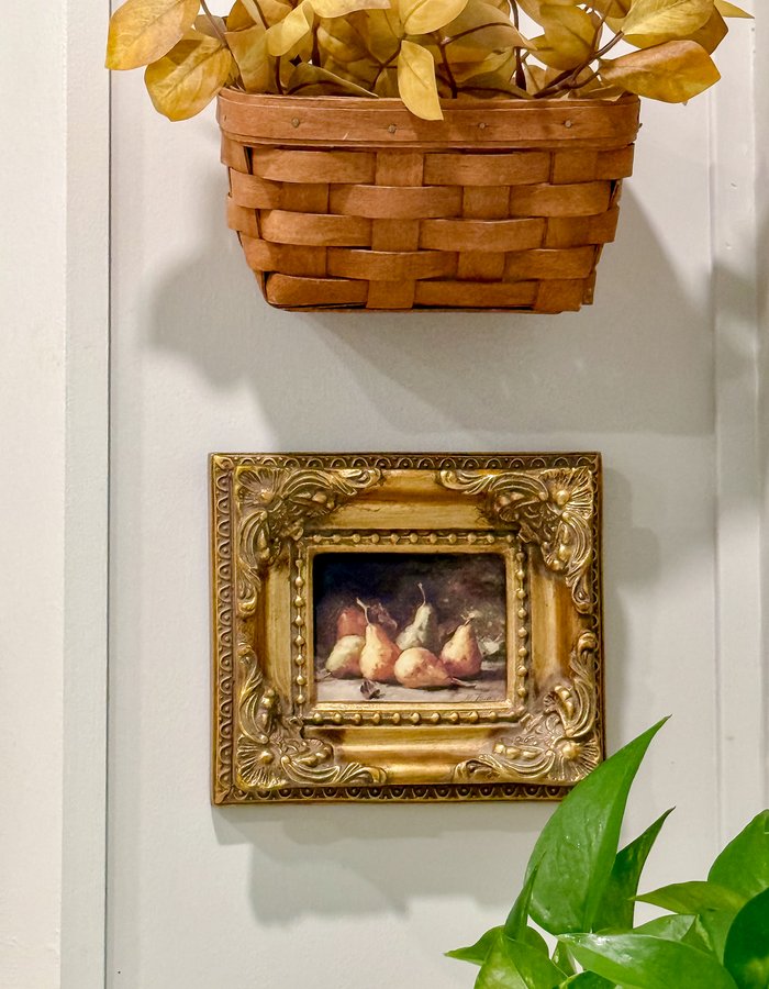 Straight-on view of the miniature gilt frame showing the painted pears in detail