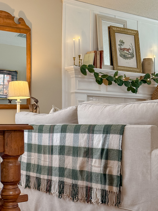 Autumn blanket in green and neutrals on the back of a sofa