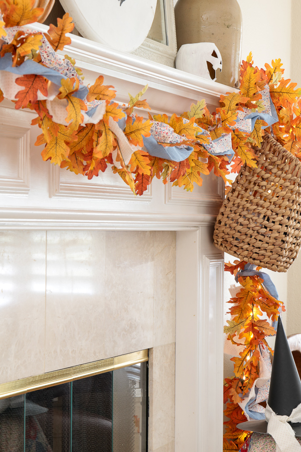Mantel garland woven with torn fabric strips in chambray blue, tiny floral, and white