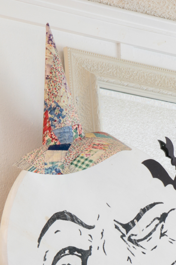 Close-up of a flat quilted witch hat made from a printed photo of a vintage quilt